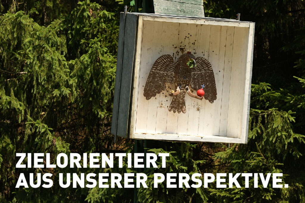 Zielorientiert aus unserer Perspektive. Ein hölzerner Vogel an der Vogelstange zum Schützenfest